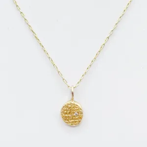 Diamond Embedded in a Textured Coin Shape