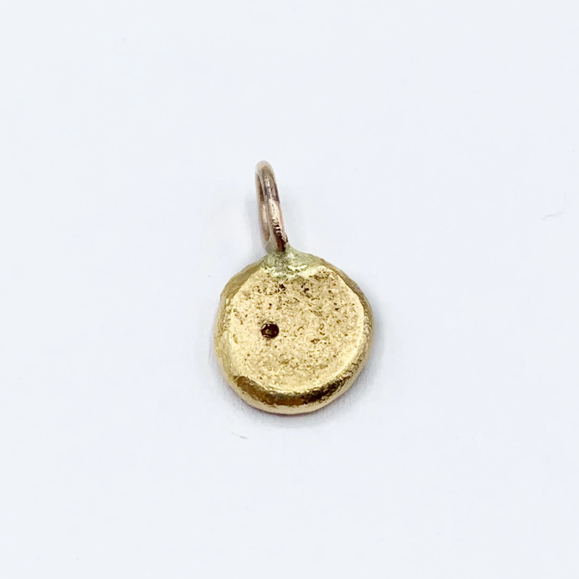 Diamond Embedded in a Textured Coin Shape