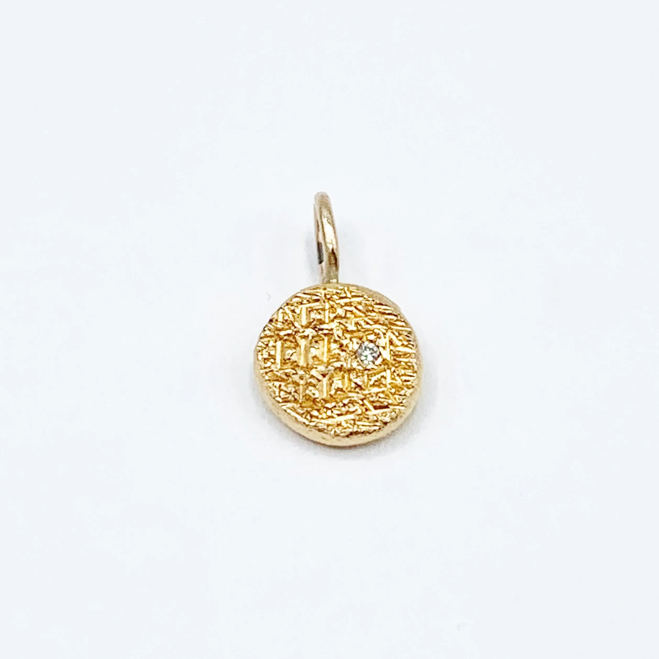 Diamond Embedded in a Textured Coin Shape