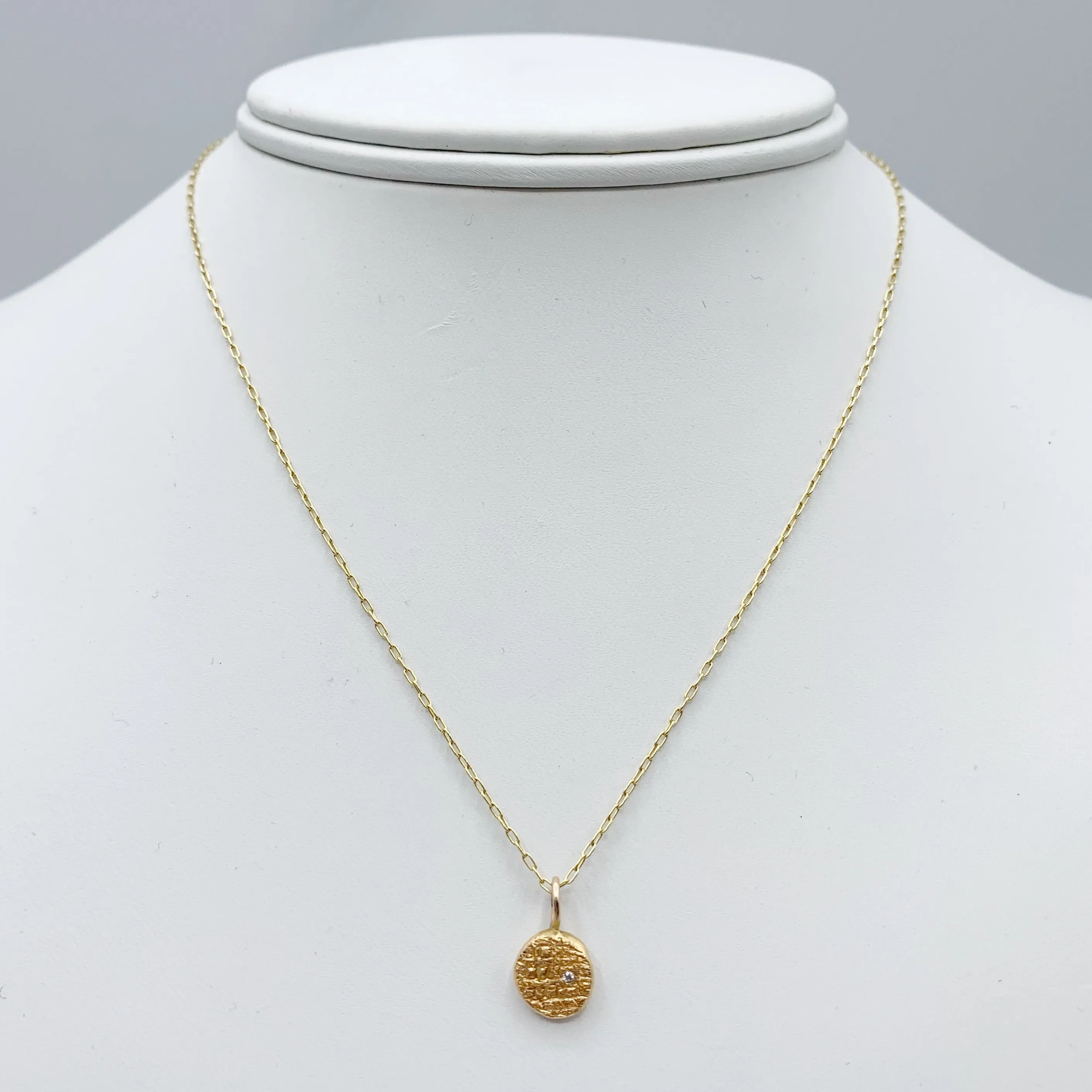 Diamond Embedded in a Textured Coin Shape